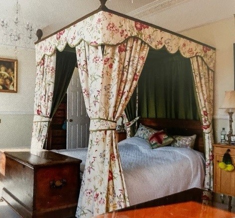 A George III style oak four poster bed frame, with drapes, length 205cm, width 152cm